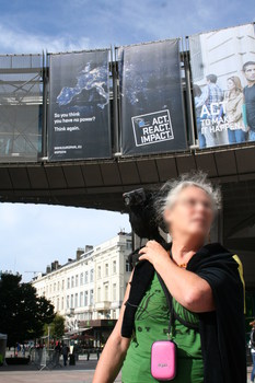[Picture: Camera raven in fron of EU building with sign saying: So you think you have no power? Think again!]