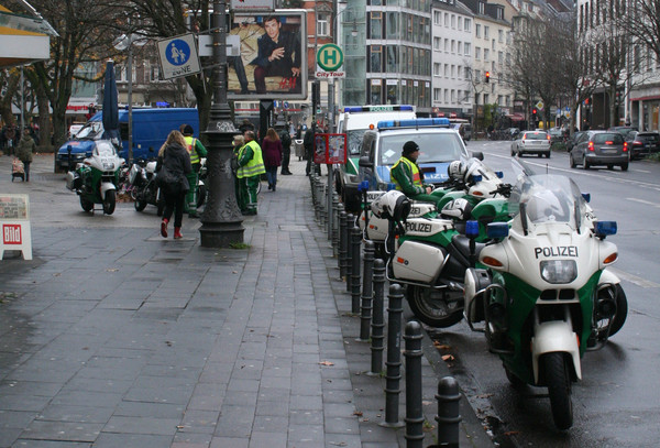 [Foto: Polizei-Motorrder und -Wagen vor Beginn der Kundgebung am Friesenplatz]