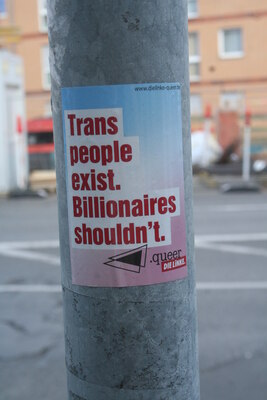 [Foto: Trans people exist. Billionaires shouldn't.]